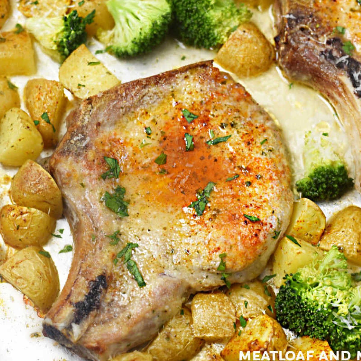 baked pork chops and potatoes on a sheet pan with broccoli