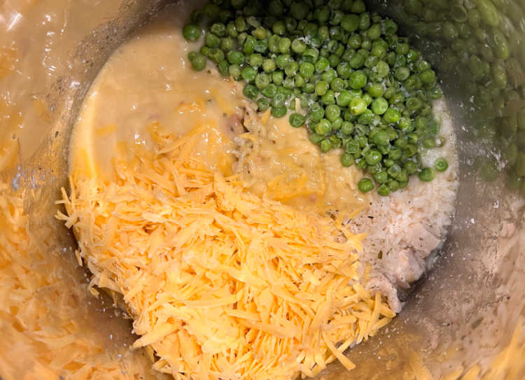 shredded cheddar cheese and peas with chicken and rice in the pressure cooker