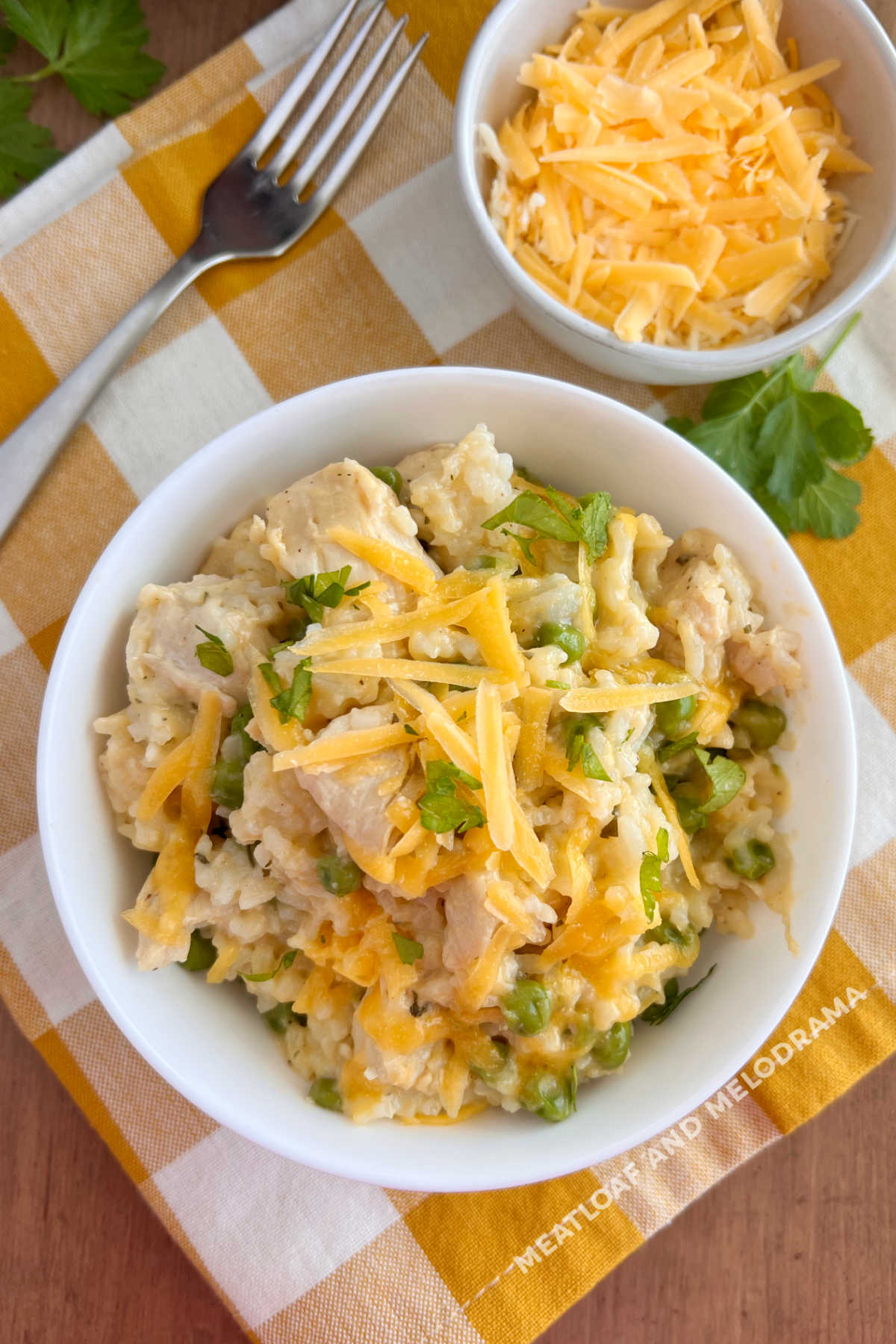 instant pot cheesy chicken and rice with peas and parsley on the table