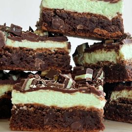 mint chocolate chip brownies with mint frosting and chocolate ganache stacked