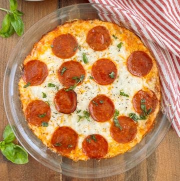 pepperoni pizza dip with basil in pie plate on the table