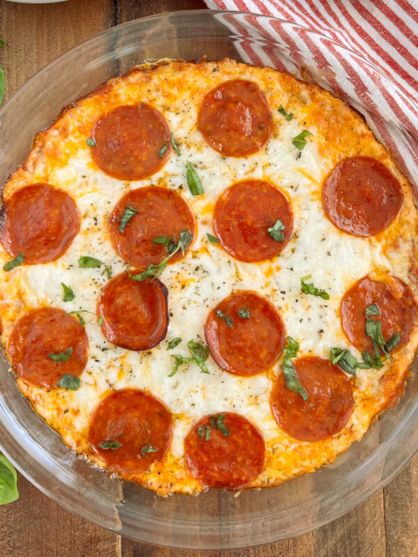 pepperoni pizza dip with basil in pie plate on the table