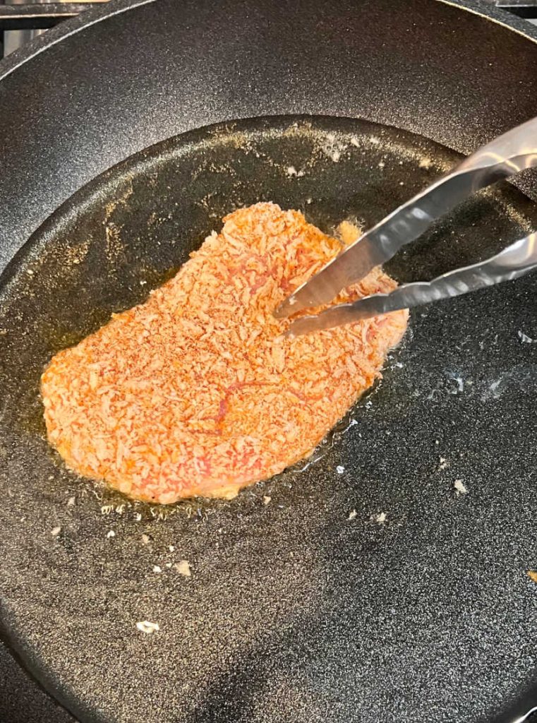 fry polish breaded pork cutlet in oil on stove