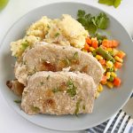 slices of slow cooker pork roast with apples on the table