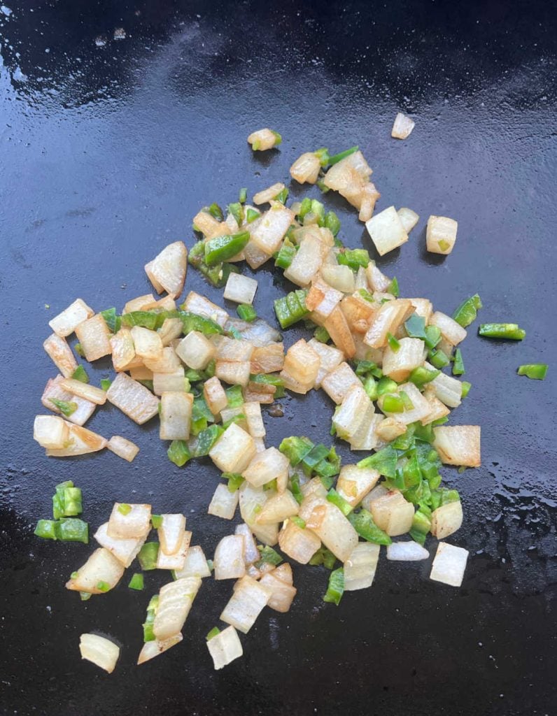 diced onions and jalapeno peppers on blackstone griddle