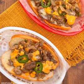 Arizona blackstone cheesesteaks with jalapeno peppers and nacho cheese on table