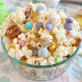 Easter bunny bait snack mix with popcorn and candy in glass bowl