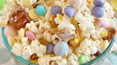 Easter bunny bait snack mix with popcorn and candy in glass bowl