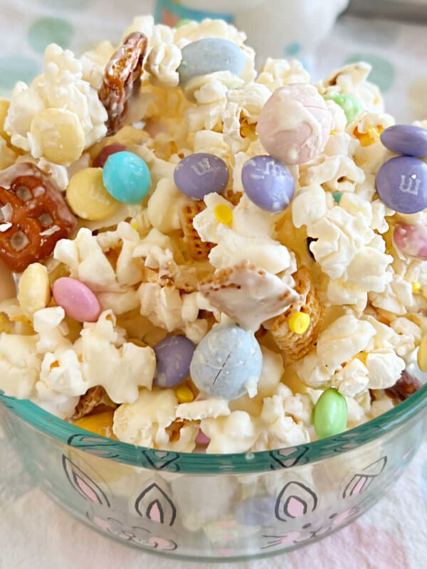 Easter bunny bait snack mix with popcorn and candy in glass bowl