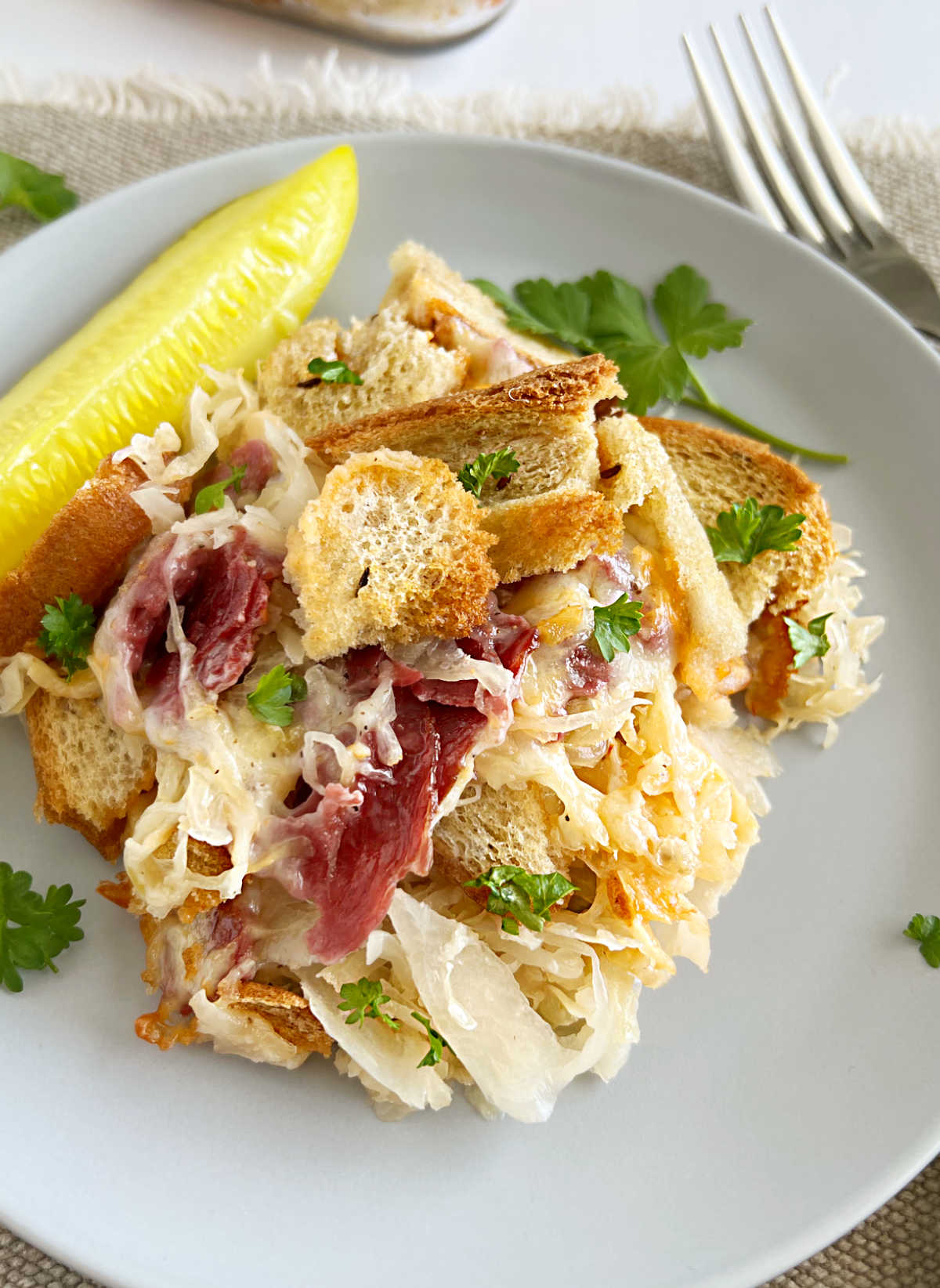 close up of reuben casserole with corned beef and sauerkraut on a plate