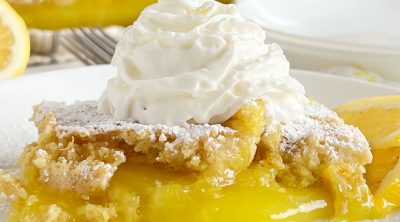 lemon dump cake with whipped cream on the table
