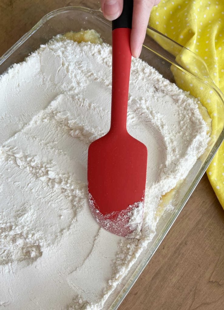 spread cake mix over crushed pineapple with spatula