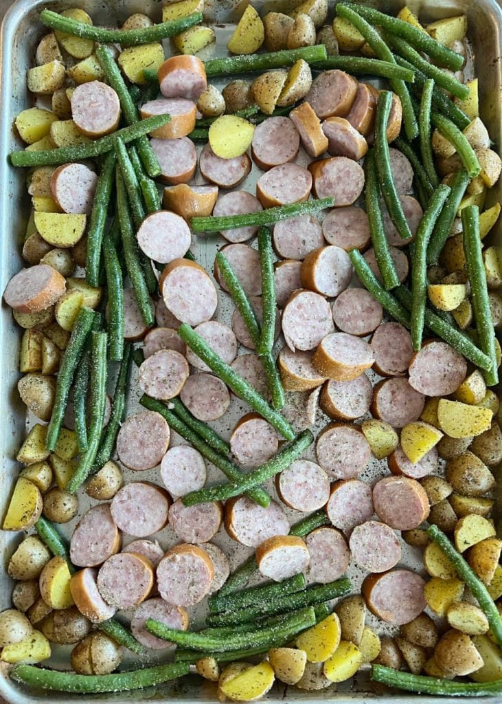 roasted baby potatoes with fresh green beans and sausage coins on sheet pan