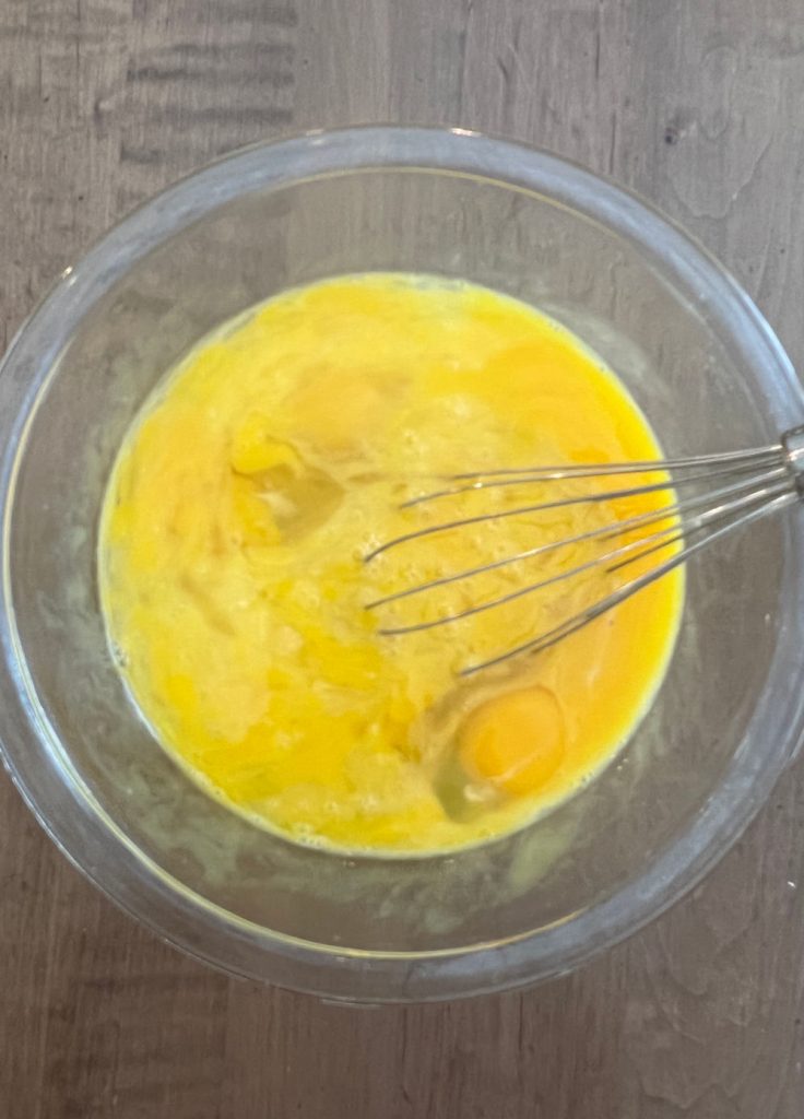 beat eggs in mixing bowl with wire whisk