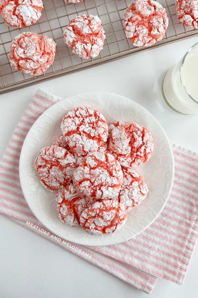 plate of strawberry crinkle cookies with milk on table