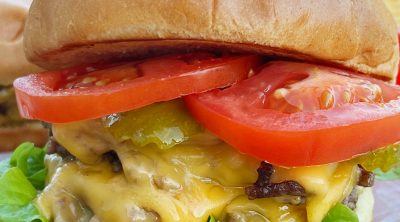 blackstone smash burger with double cheeseburgers, lettuce and tomato on brioche bun