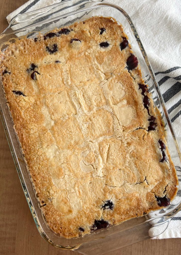 baked blueberry dump cake with golden brown topping on table