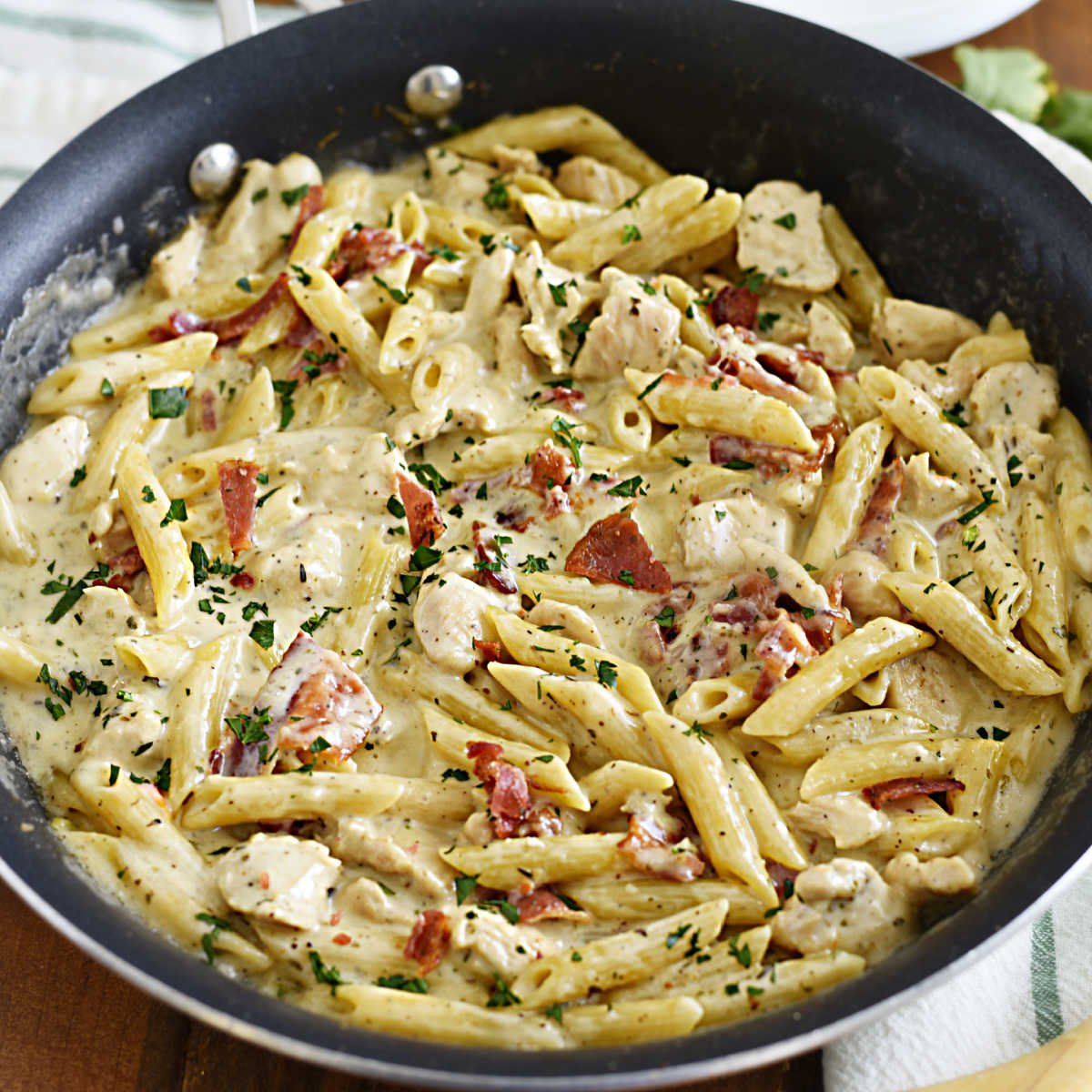 chicken bacon ranch pasta in skillet with parsley