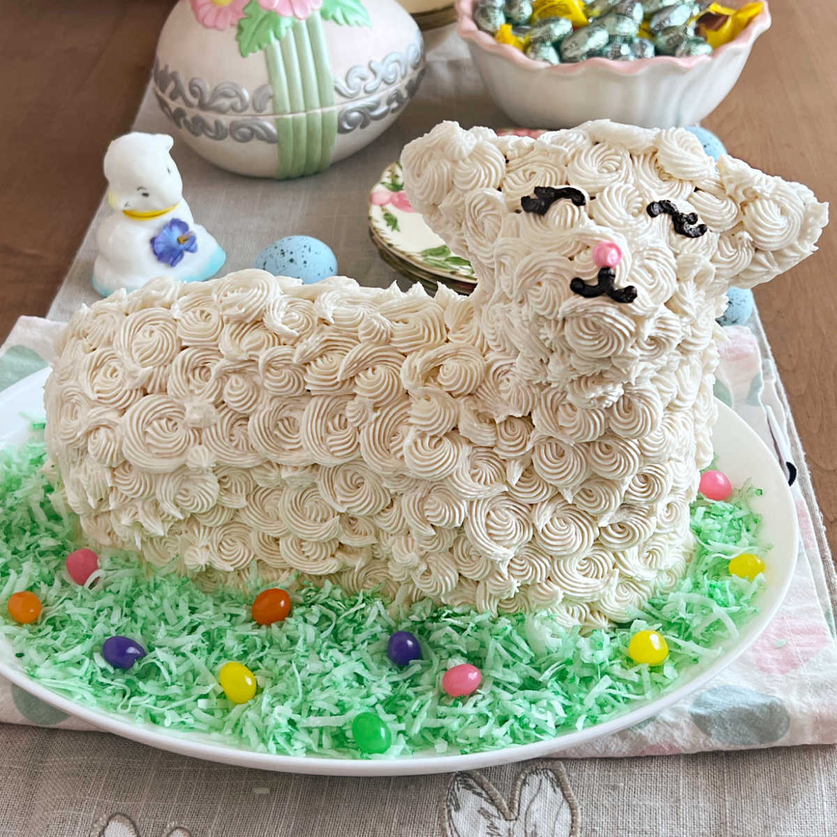 easter lamb cake decorated with buttercream frosting, colored coconut and jelly beans