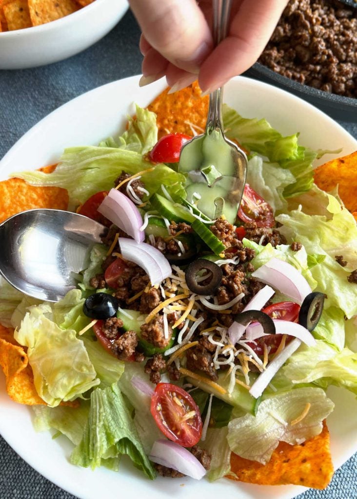 mix taco meat with doritos and salad