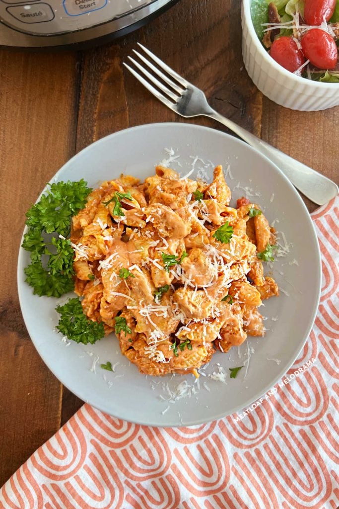 instant pot creamy chicken pasta with parsley and Parmesan cheese on the table