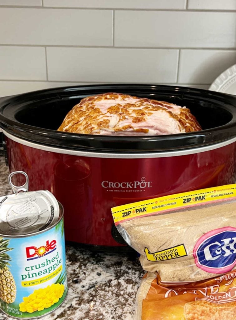 crushed pineapple and brown sugar and spiral ham in crock pot on counter