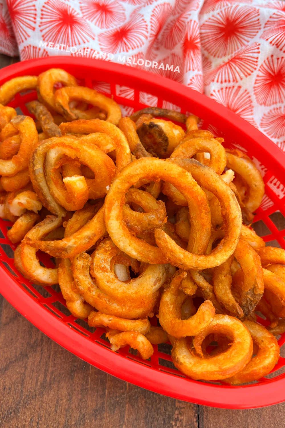 air fryer frozen curly fries in red serving basket