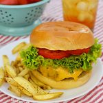 air fryer hamburger with cheese on a plate with french fries