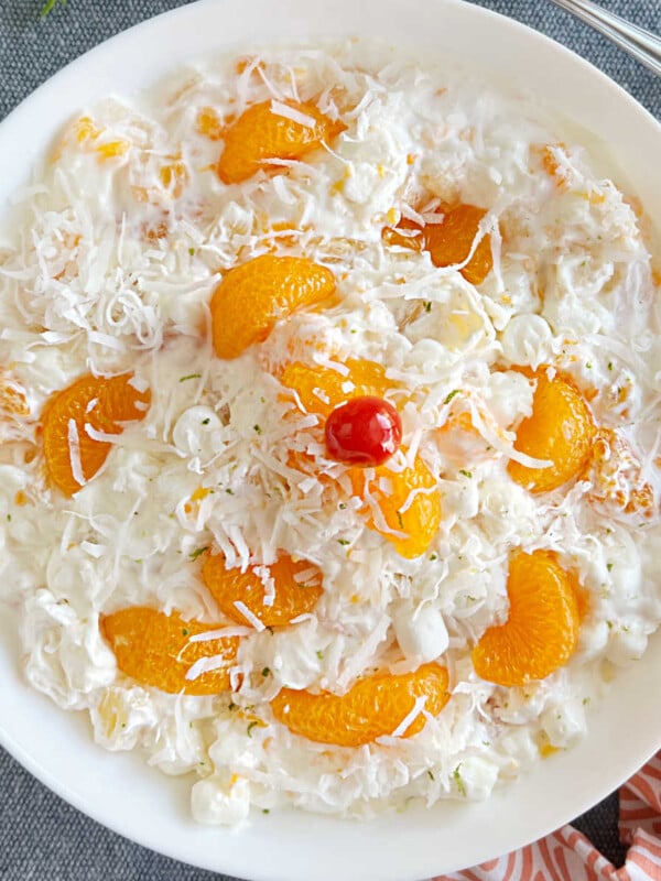 ambrosia fruit salad recipe with sour cream and mandarin oranges in white serving bowl