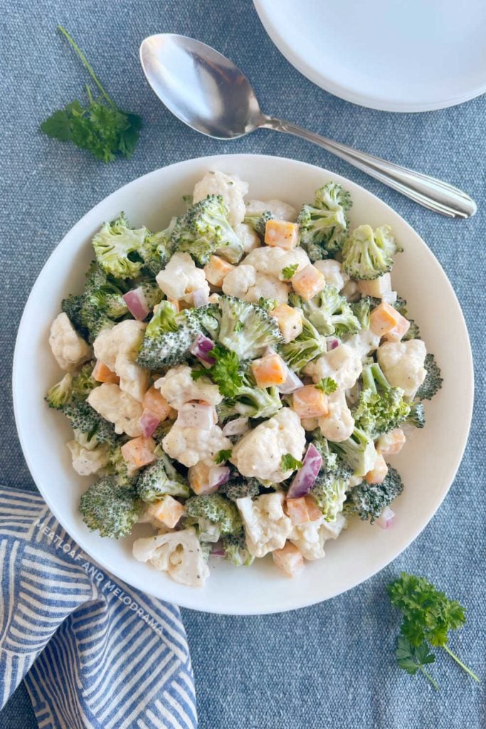 broccoli cauliflower salad in white bowl on the table