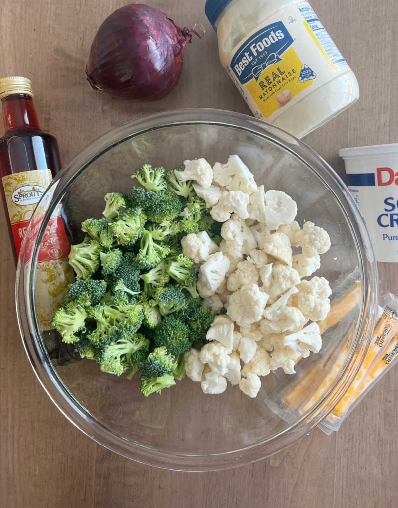 broccoli florets, cauliflower florets, mayo, red onion, sour cream, cheese and red wine vinegar