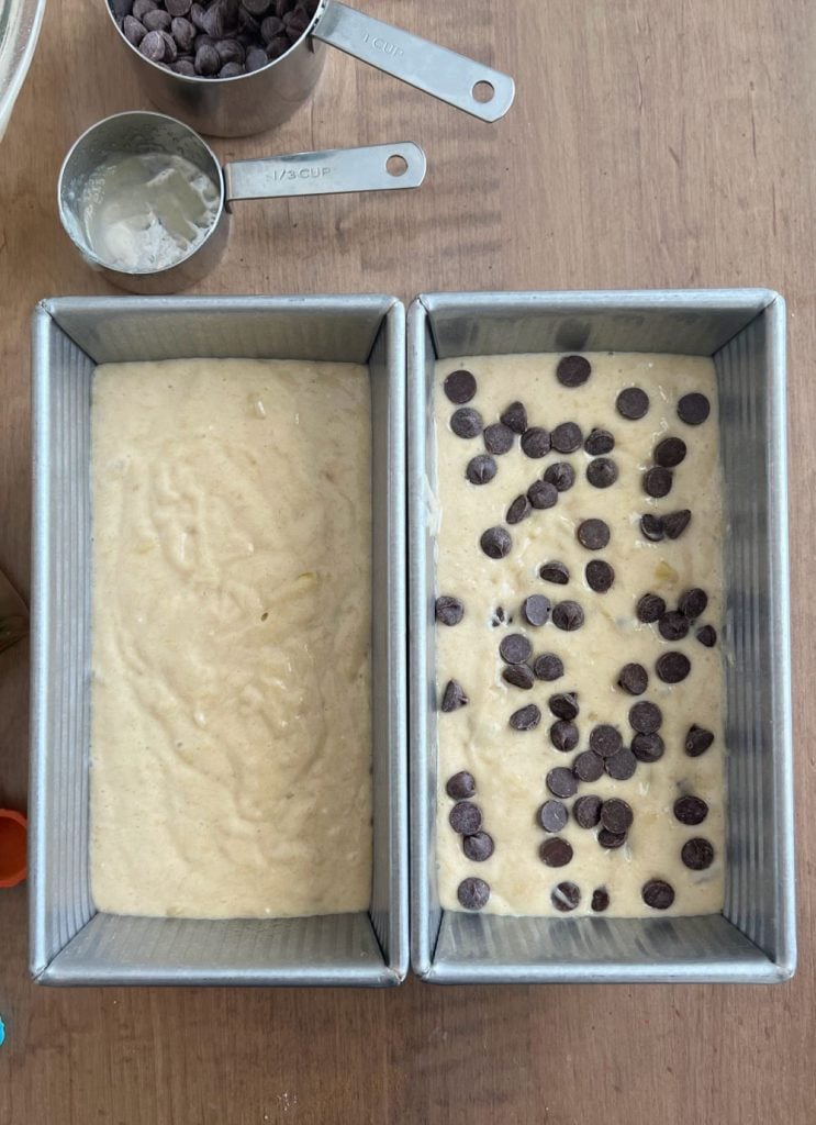 2 loaves of banana bread batter in bread pans with chocolate chips