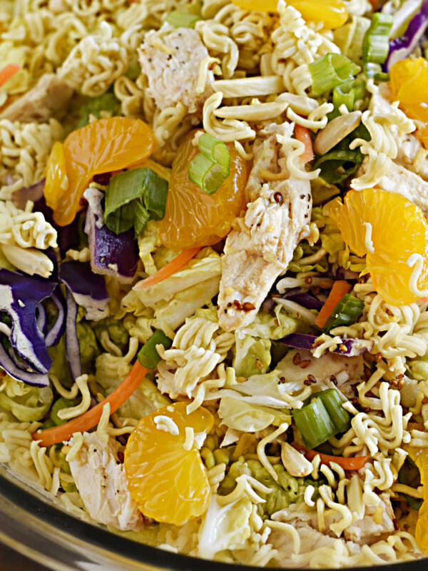 chinese ramen chicken salad with crunchy ramen noodles, napa cabbage and mandarin oranges in a serving bowl