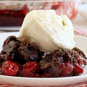 chocolate cherry dump cake with chocolate cake mix and cherry pie filling on a plate
