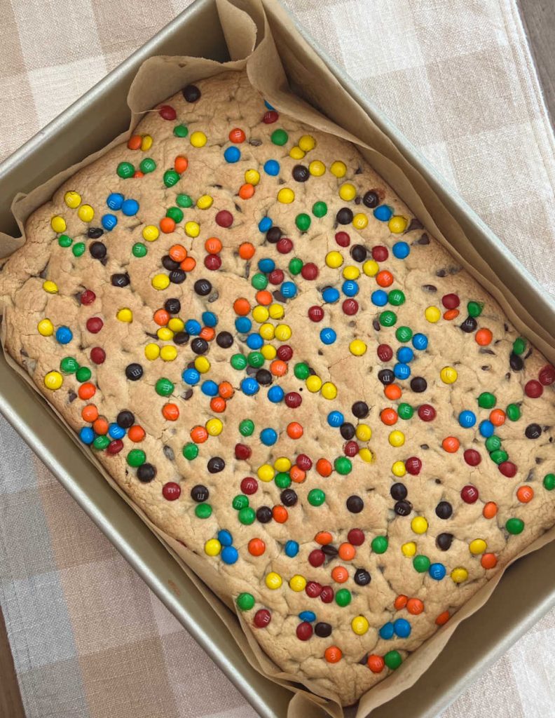 pan of chocolate chip cake mix cookie bars with m and ms on the table