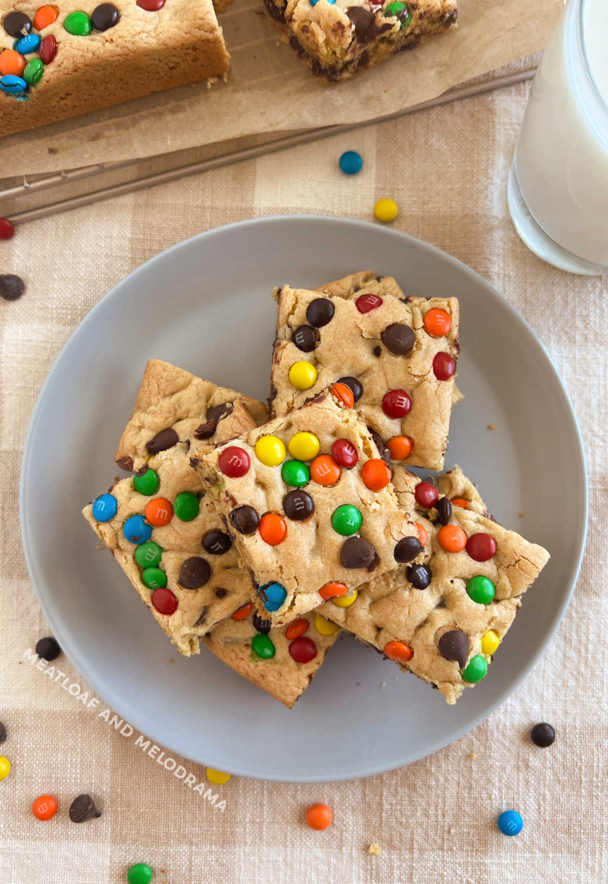 plate of cake mix cookie bars with chocolate chips and m and m candies on the table