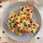 easy cake mix cookie bars with chocolate chips and m and m candies on a plate