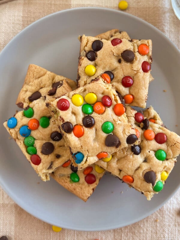 easy cake mix cookie bars with chocolate chips and m and m candies on a plate