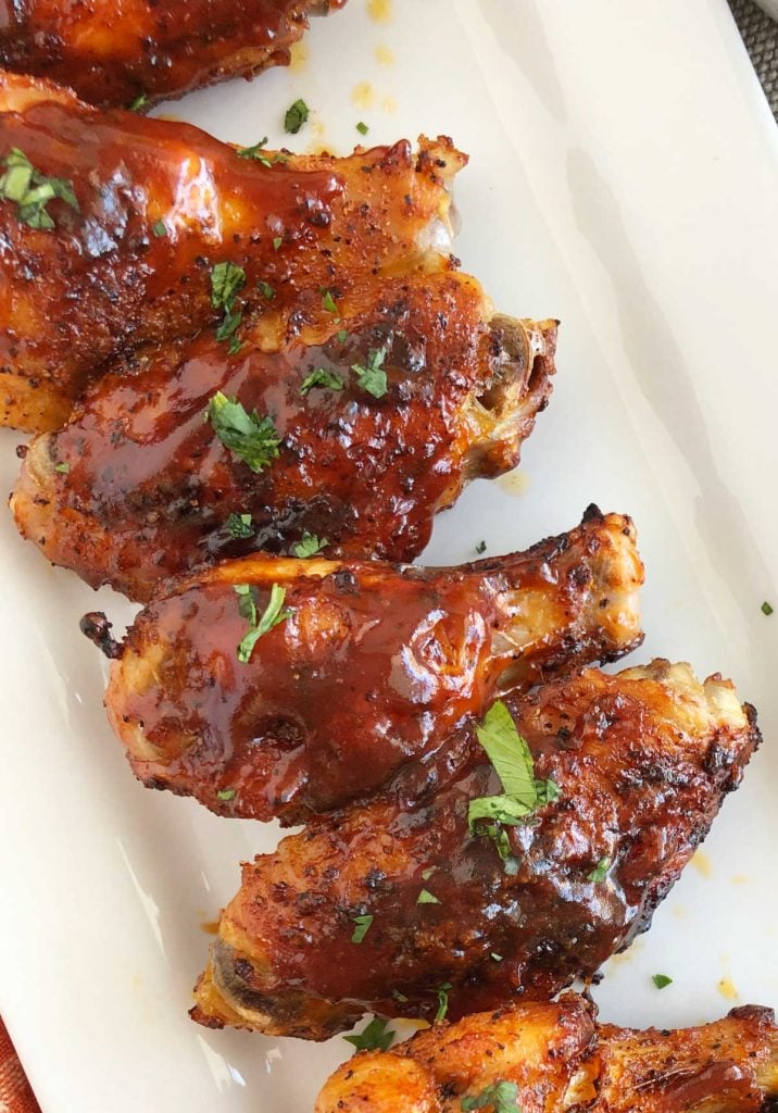 crispy air fryer bbq chicken wings with dry rub and bbq sauce on platter