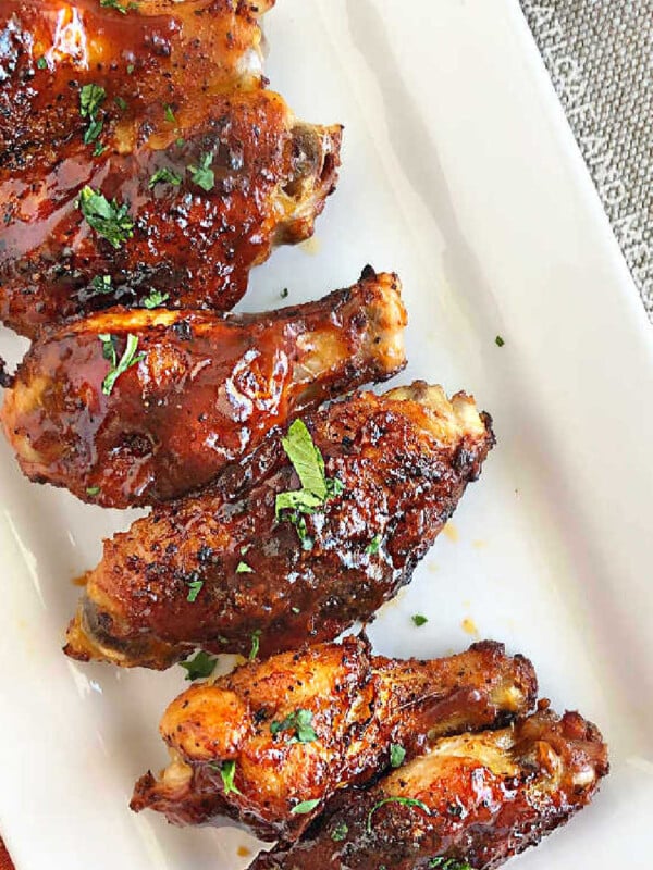air fryer bbq chicken wings with barbecue sauce on platter