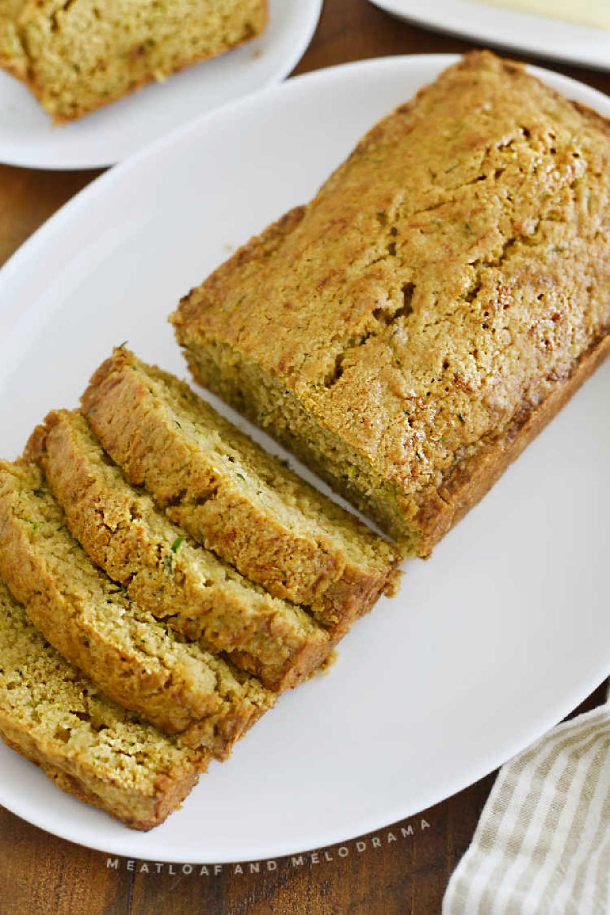 old fashioned zucchini bread loaf sliced on a white platter