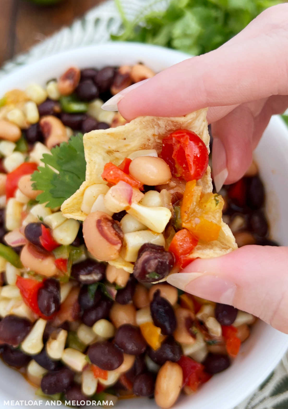 black eyed pea salsa on tortilla chip in hand