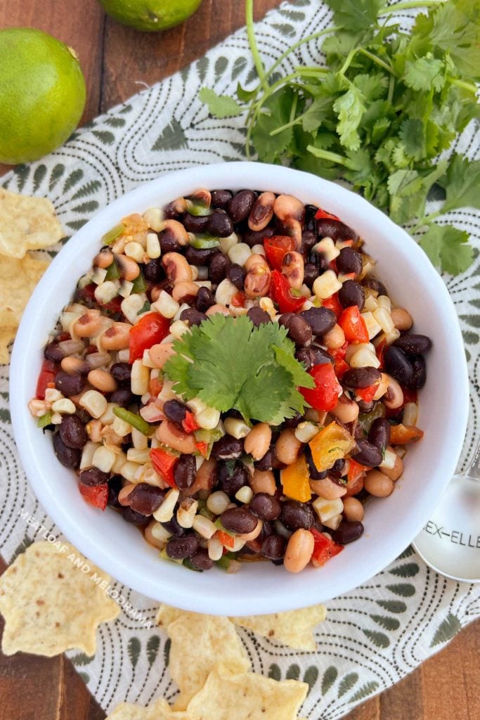 black eyed pea salsa or cowboy caviar with tortilla chips in a white bowl