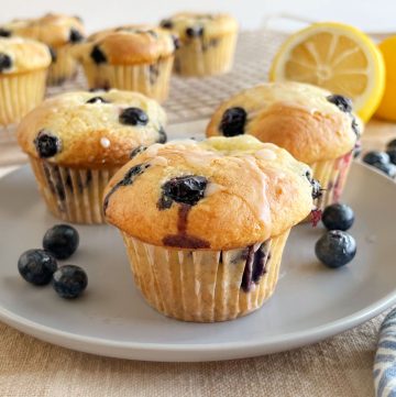 cake mix blueberry muffins with glaze on a plate