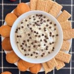 chocolate chip dip with mini chocolate chips in a bowl with graham crackers and cookies