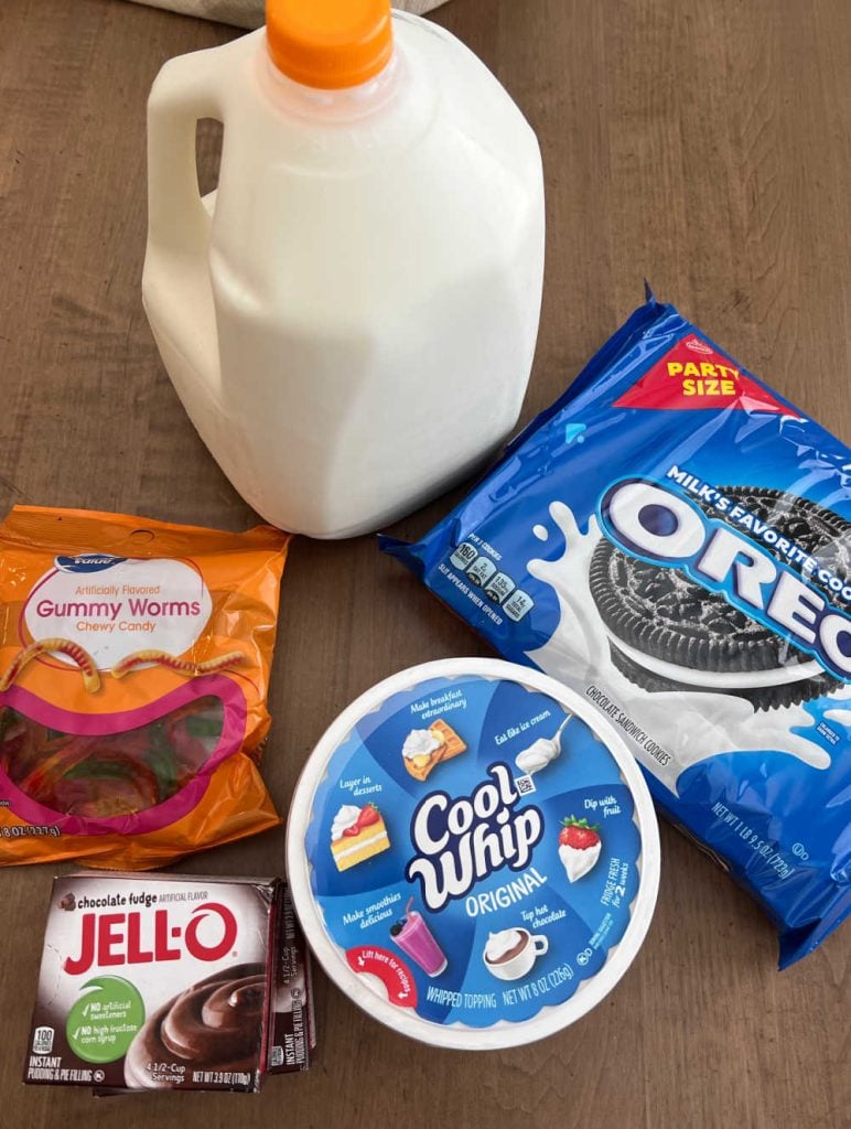 chocolate Jello pudding, gummy worms, cool whip, oreo cookies and milk