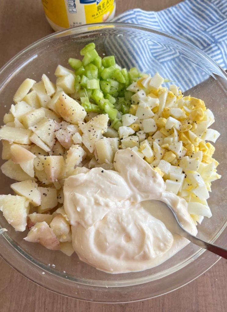 mix mayonnaise with potato salad ingredients in mixing bowl