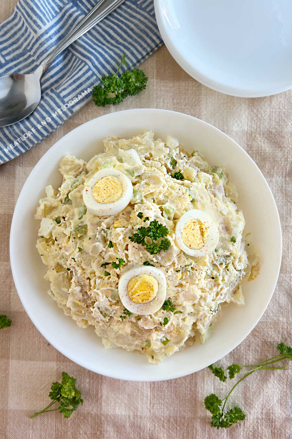 grandma's potato salad with sliced hard boiled eggs in serving bowl