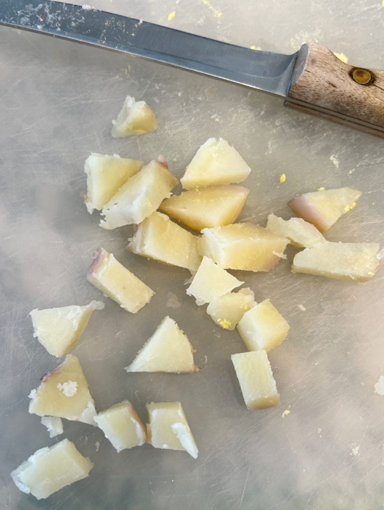 peeled cubed red potatoes on cutting board