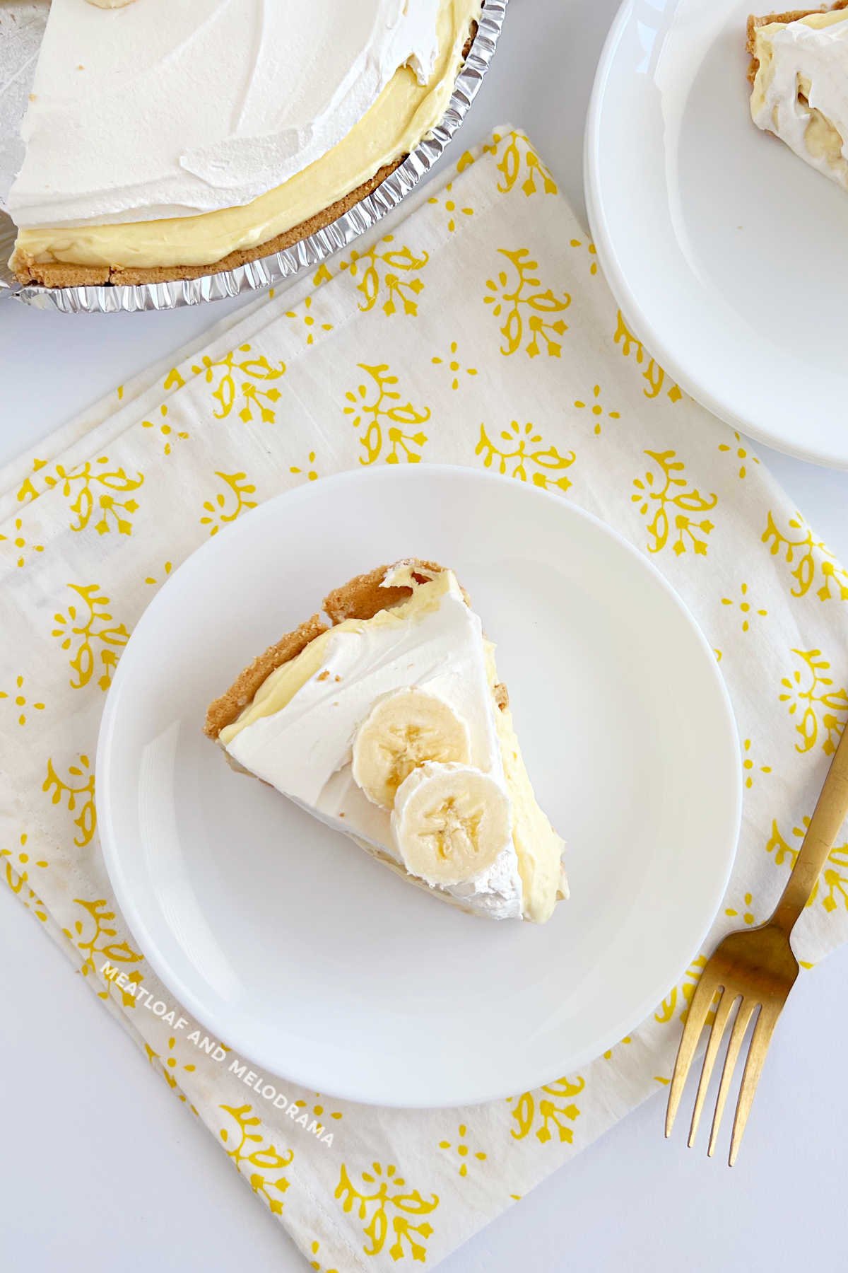 slice of banana pudding pie on plate with fork